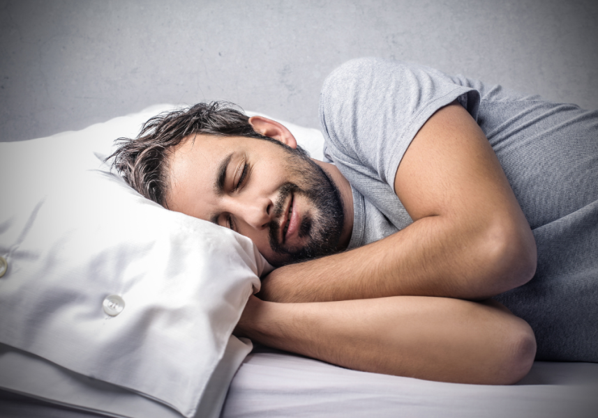 Fermata Integrated Health - Happy Guy Sleeping In Bed With Head On Pillow - Naturally Improve Sleep Quality Blog