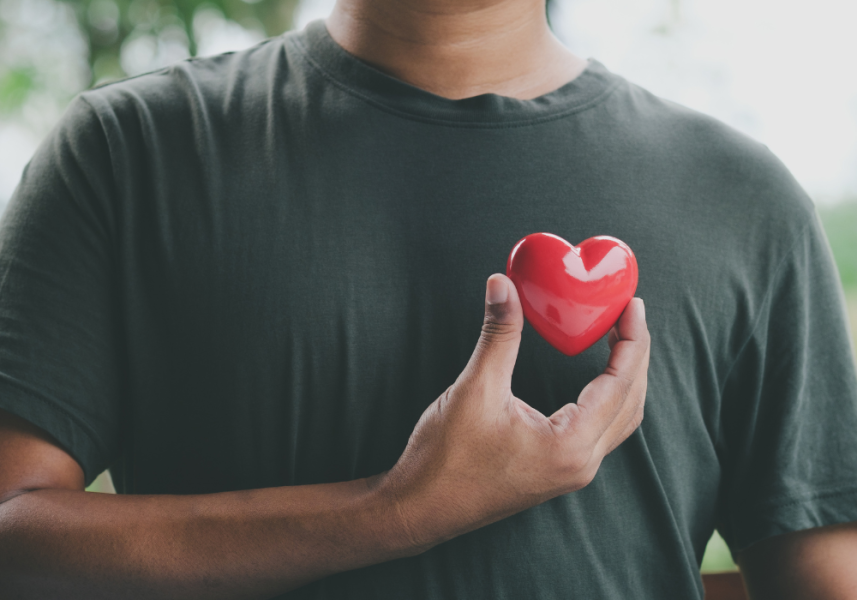 Fermata Integrated Health - Man Holding Red Heart Up To Chest - Connection Between Mental And Physical Health Blog